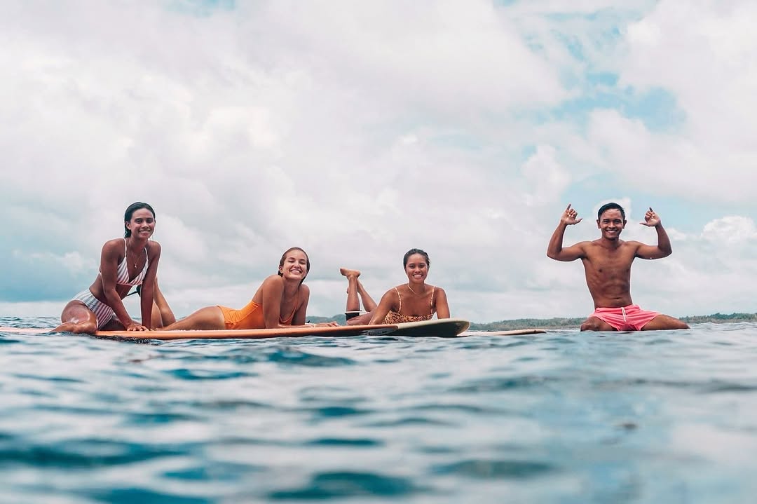 Surfers resting on boards in the ocean